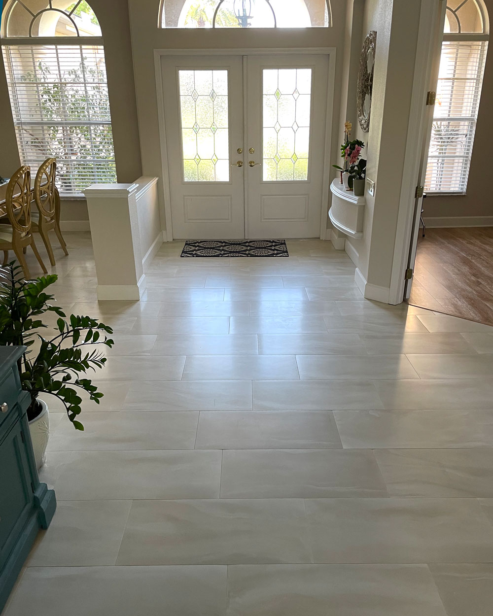 Entryway with white and grey tile planks