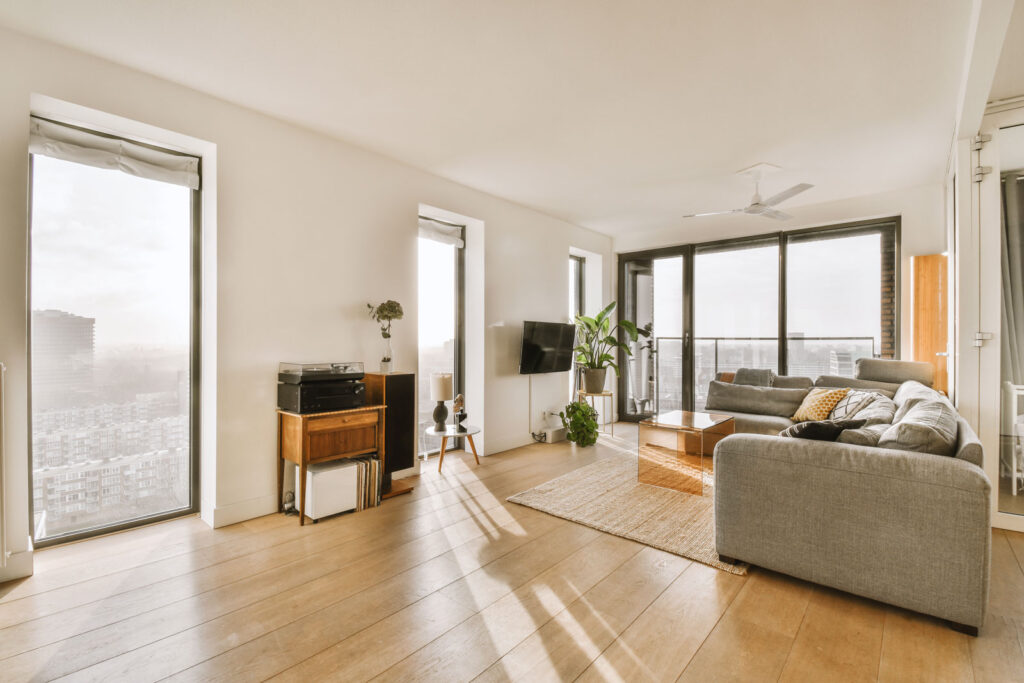 High rise apartment living room with light brown hardwood floors